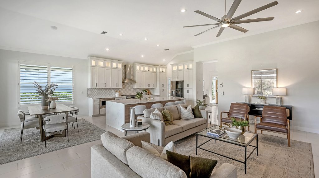 Beautifully staged open living room in a Central Florida home, featuring neutral tones, modern furniture, and abundant natural light to create an inviting space.