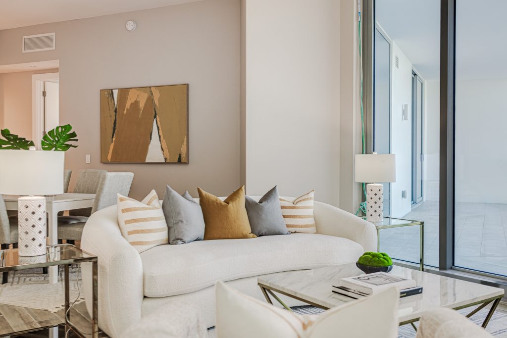 Marina Way Staged Home room in Central Florida with neutral furnishings, lush greenery, and modern artwork creating a stylish and inviting space.