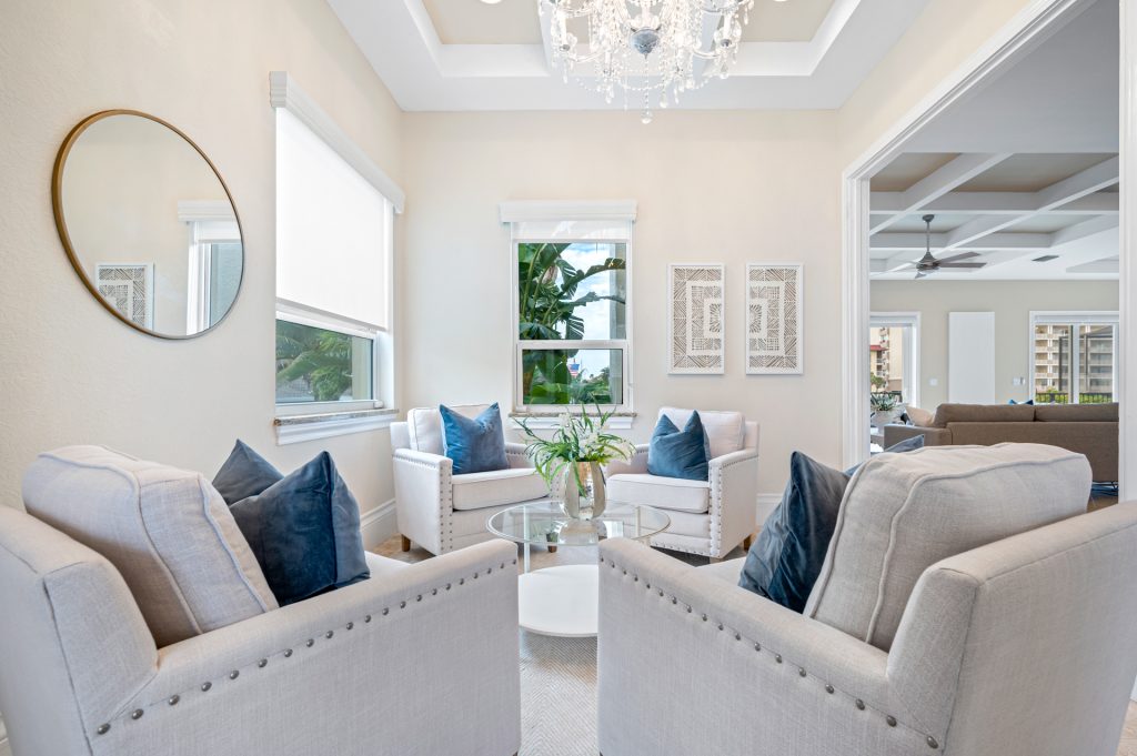 Luxurious staged living room in a Central Florida home, featuring elegant furnishings, soft neutral tones, and abundant natural light.