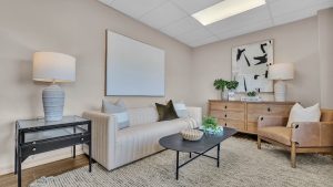 Luxury Home Staged in Central Florida with modern artwork, lamps, and a beige couch